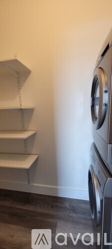 A modern staircase with a washing machine on the side.