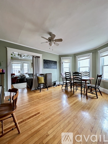 A room with wooden floors and a ceiling fan.