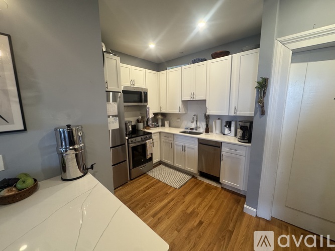 A kitchen with white cabinets and stainless steel appliances.