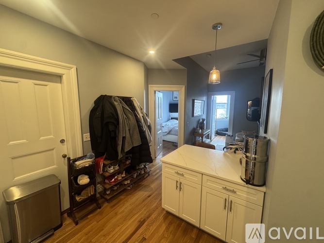 A room with a wooden floor and a white door.
