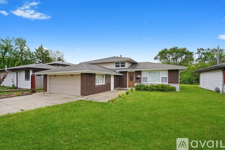 A house with a brown roof and a white garage door is for sale.