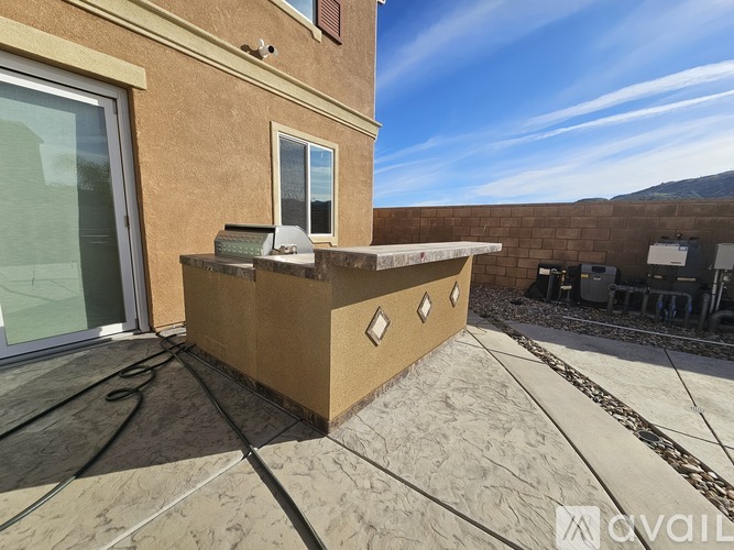 A house with a brown exterior and a patio with a box on it.