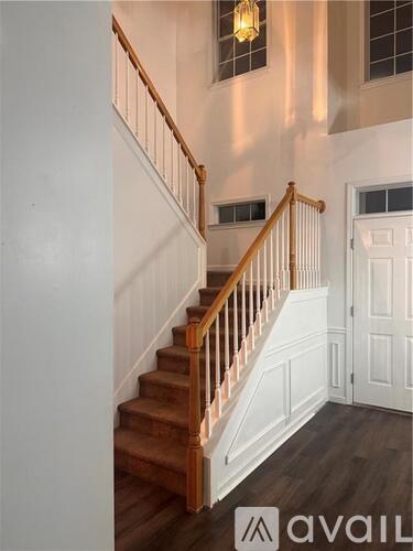 A staircase with wooden steps and white railings.