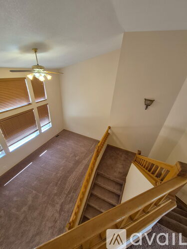A staircase with wooden railings leads up to a second floor.