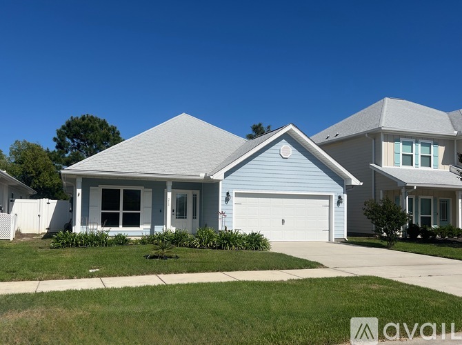 A house with a blue garage door is for sale.