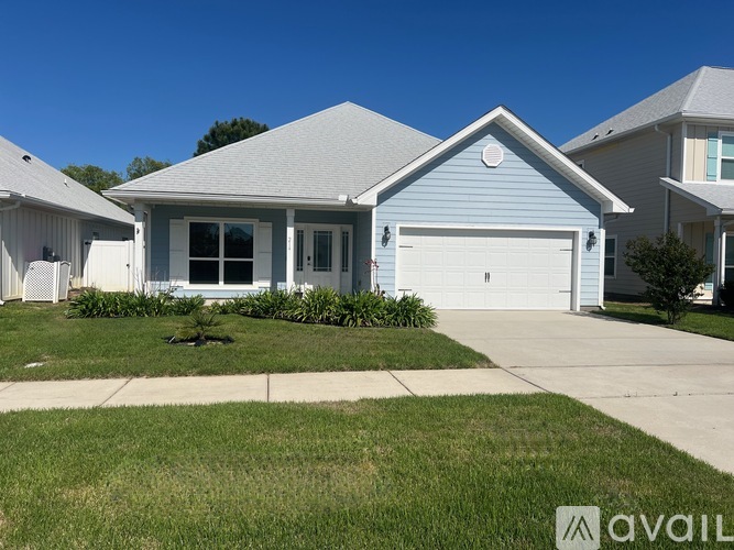 A house with a blue front and a garage door.
