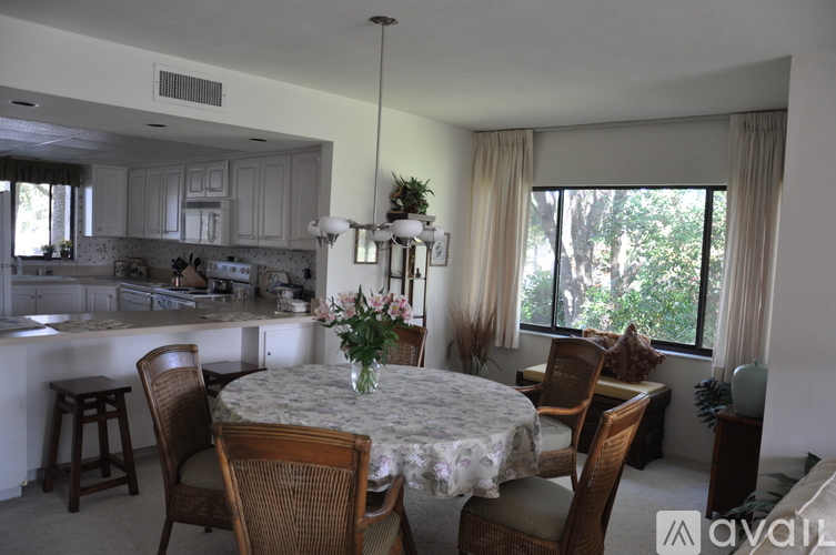 A dining room with a table set for six.