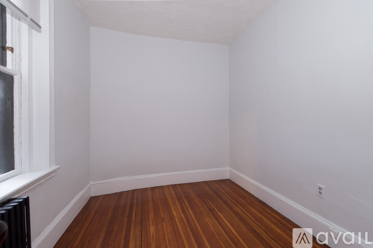 A room with wooden floors and white walls.