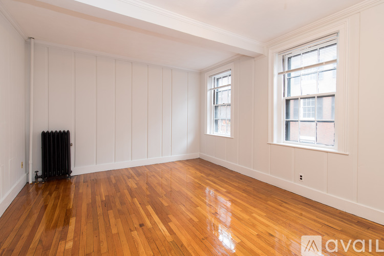 A room with wooden floors and white walls.