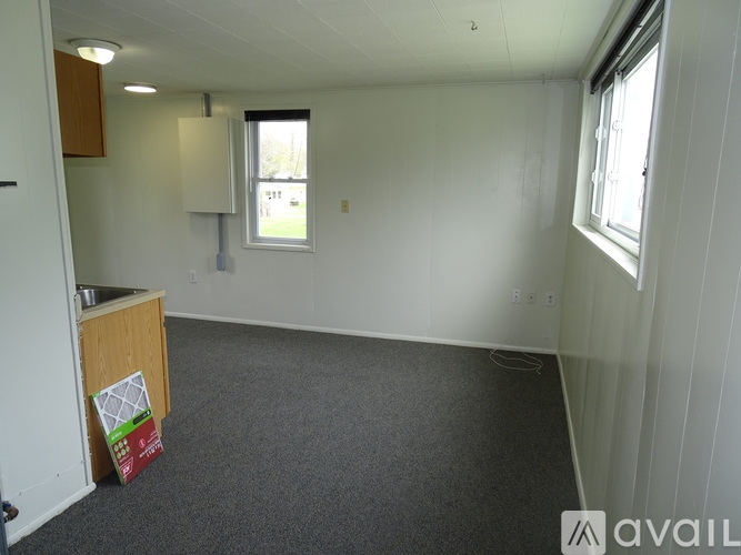 A room with a window and a sink.