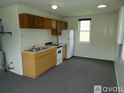 A kitchen with wooden cabinets and a white refrigerator.