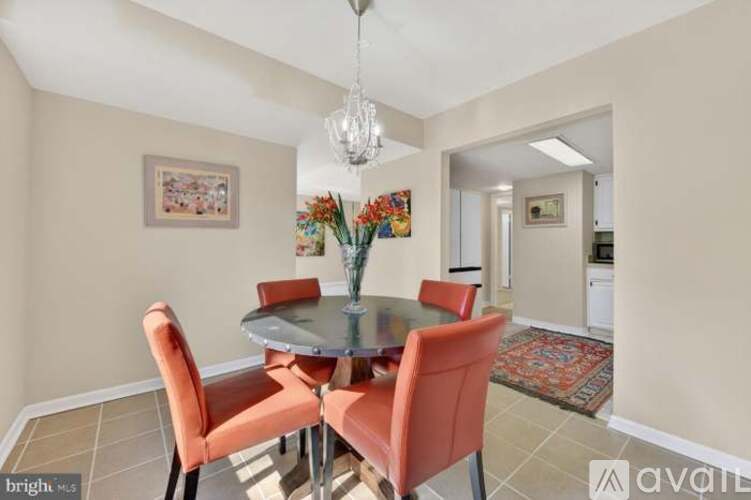 A dining room with a glass table and chairs.