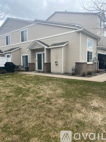 A house with a front yard and a driveway.