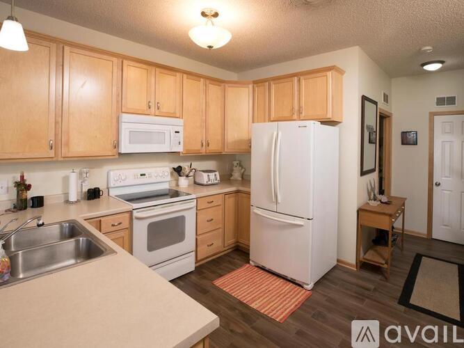 A kitchen with wooden cabinets and a white refrigerator.