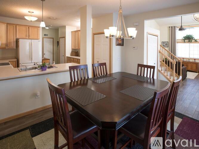 A dining room with a table and chairs.