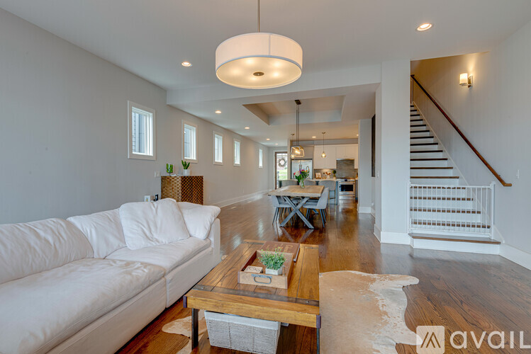 A living room with a white couch and a wooden coffee table.
