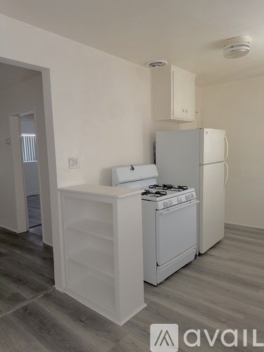 A kitchen with a white fridge and a white stove top oven.