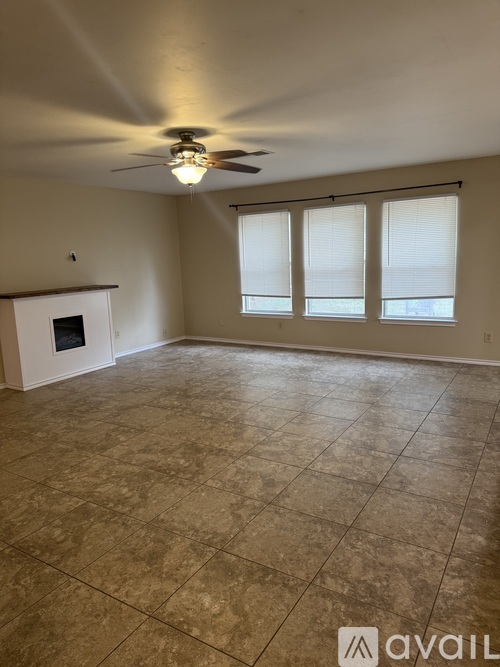 A room with a tiled floor and a ceiling fan.