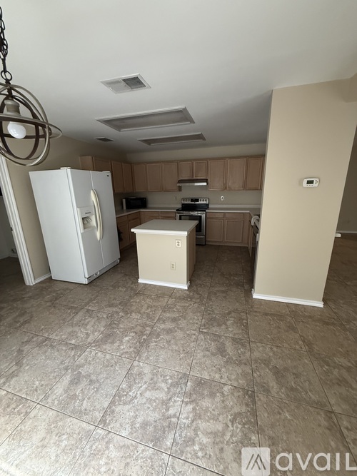 A kitchen with a white fridge and a white microwave.