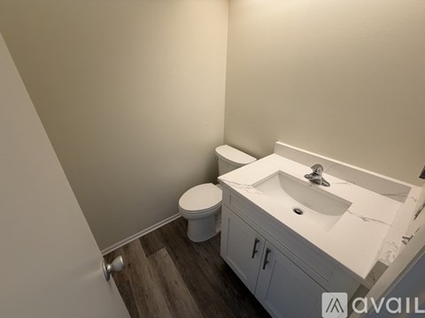 A white sink and toilet in a small bathroom.