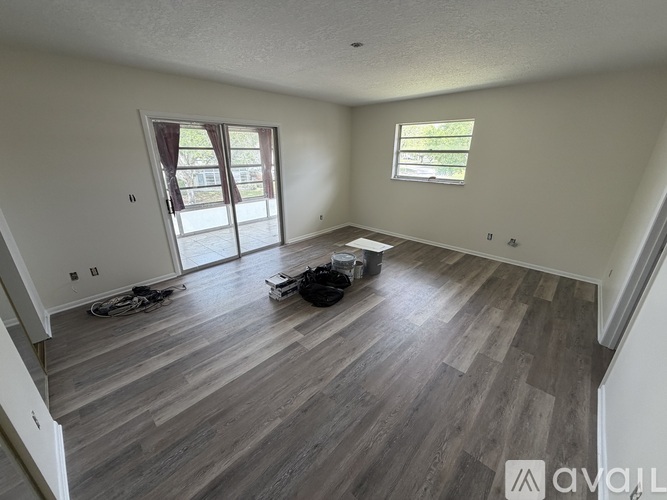 A room with wooden flooring and a bicycle is available.