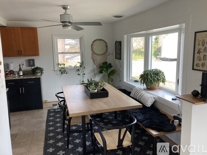 A dining room with a table and chairs.