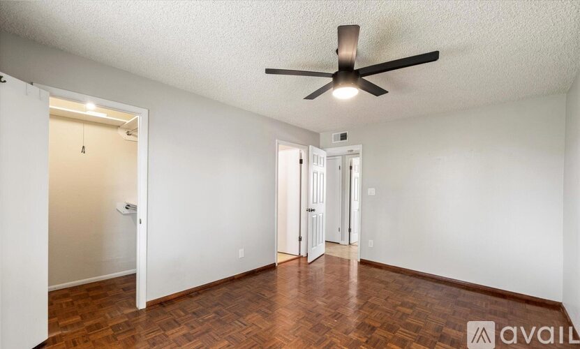 A spacious living room with a fireplace and wooden flooring.