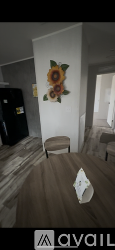 A bedroom with a bed and a wall decoration.