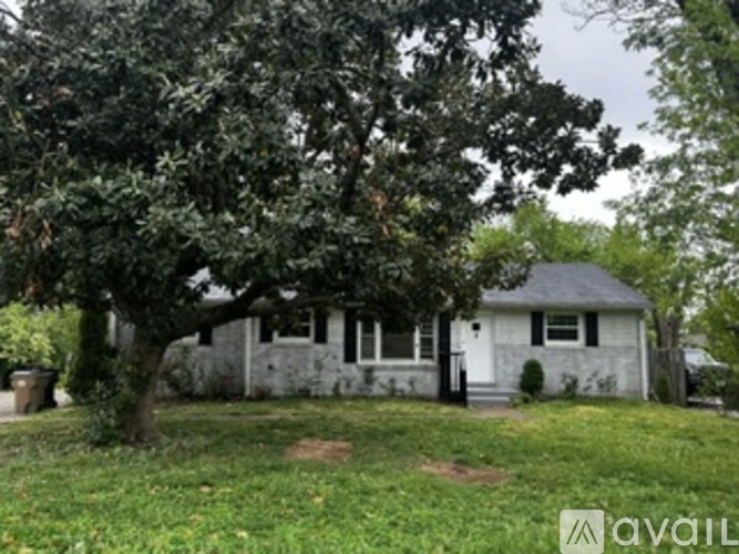 A house with a tree in front of it.