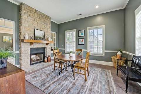 A cozy living room with a fireplace and a dining table set up.