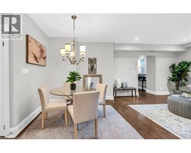 A dining room with a table set for four.