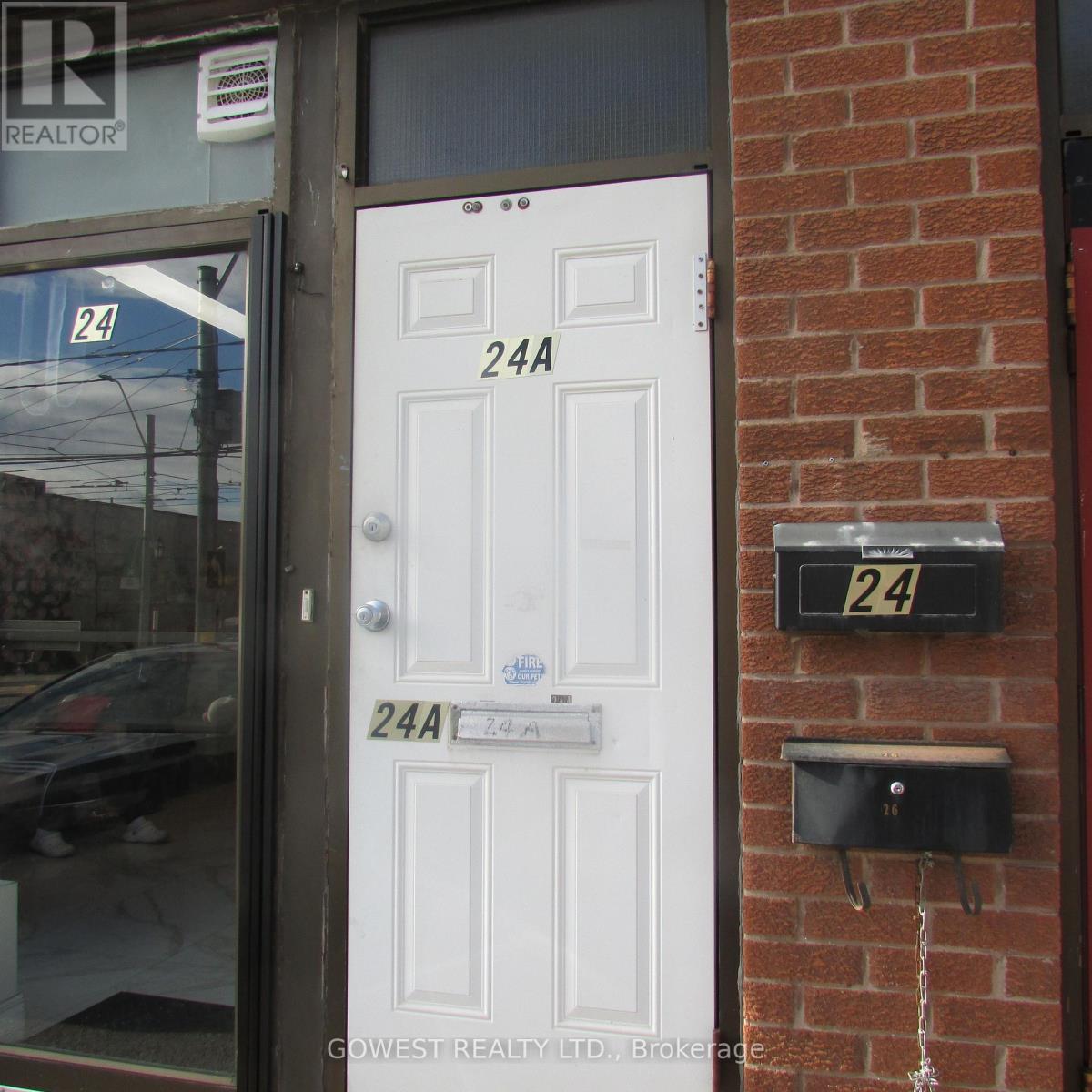 A white door with a sign that says 24A.