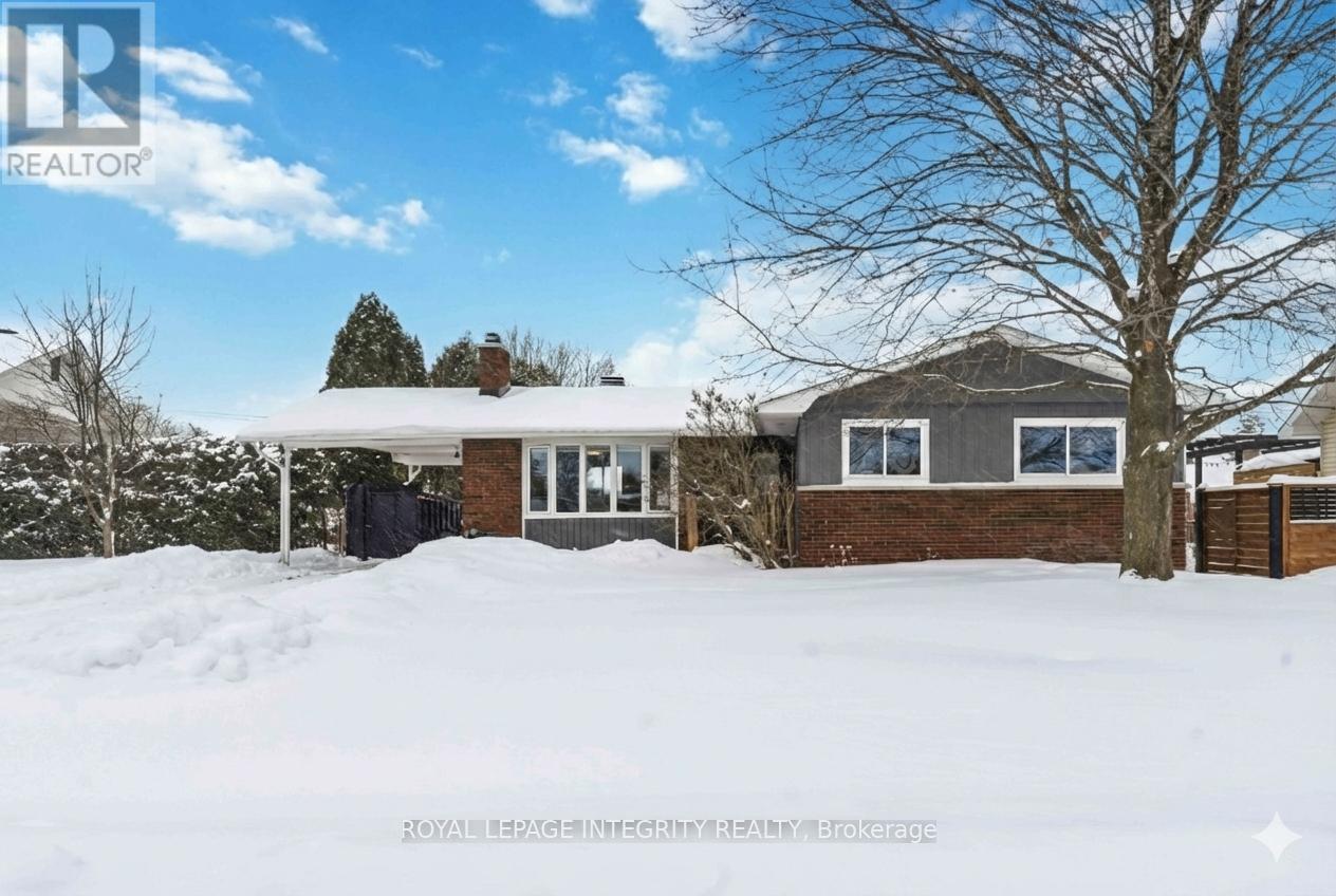 A house with a snow-covered ground in front of it.