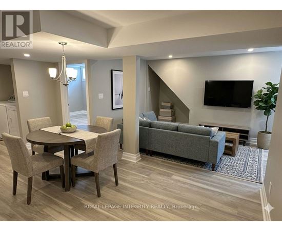 A well-lit living room with a dining table and a couch.