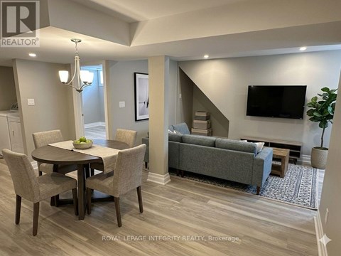 A well-lit living room with a dining table and a couch.