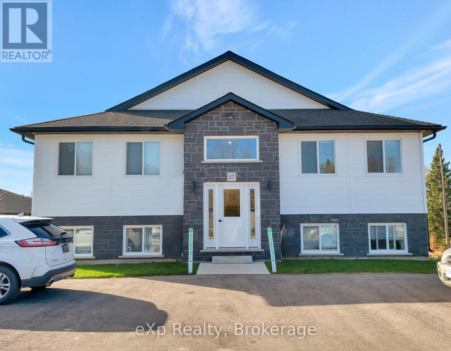 A house with a white door and windows is for sale.
