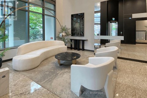 A modern living room with a white sofa and a glass table.