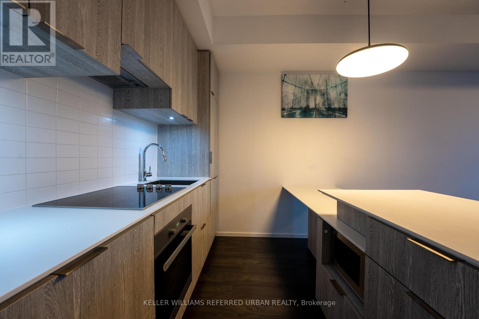 A modern kitchen with wooden cabinets and a white countertop.