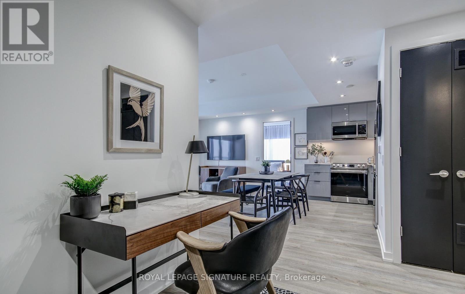 A modern kitchen with a dining table and chairs in the foreground.