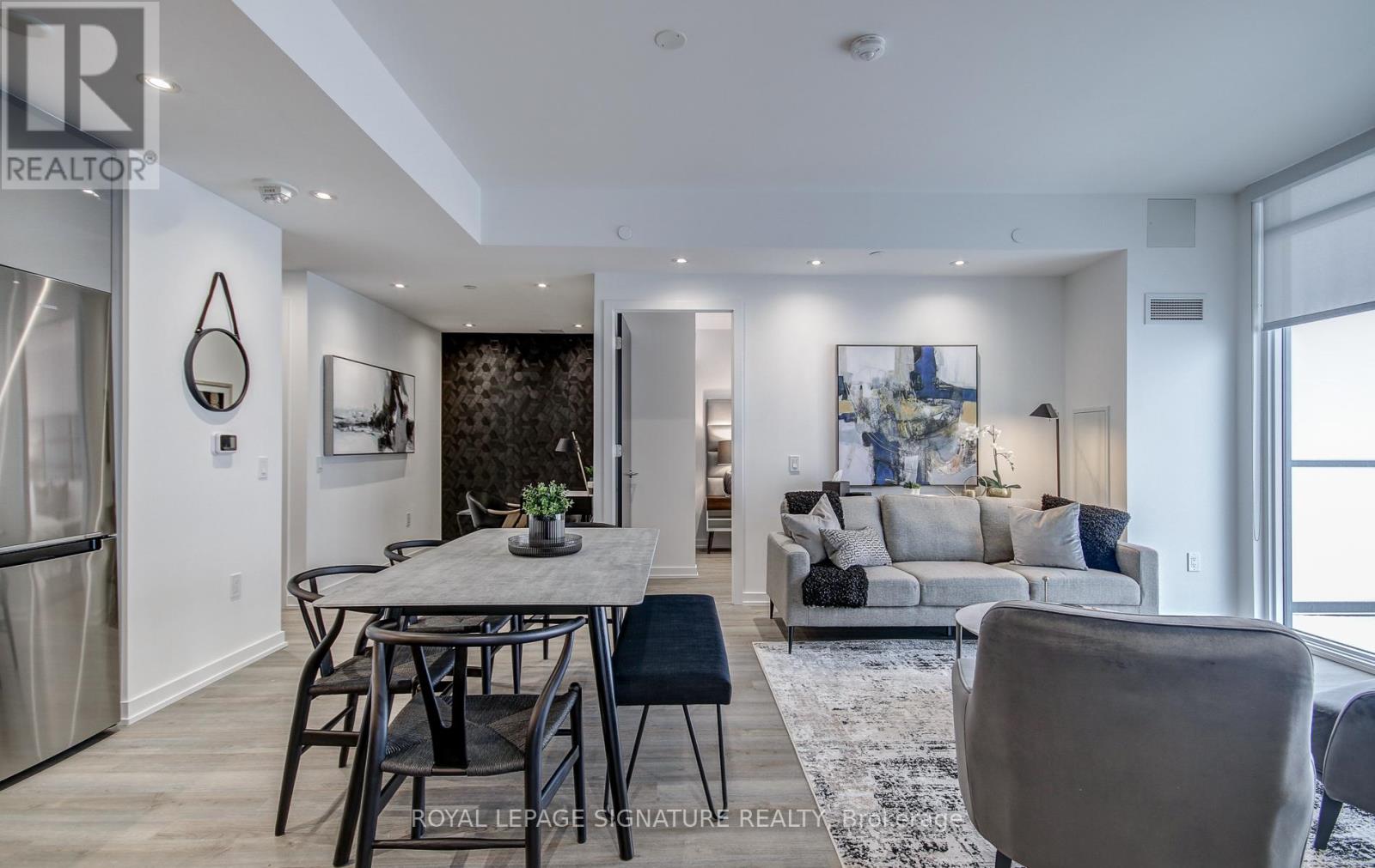 A modern dining room with a table set for four.