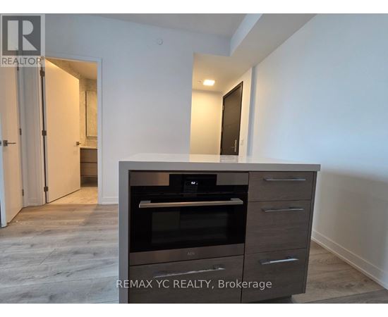 A modern kitchen with a built-in oven and microwave.
