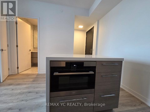 A modern kitchen with a built-in oven and microwave.