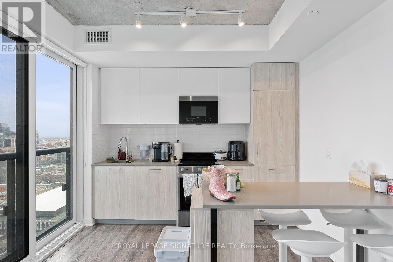 A modern kitchen with white cabinets and a large island.
