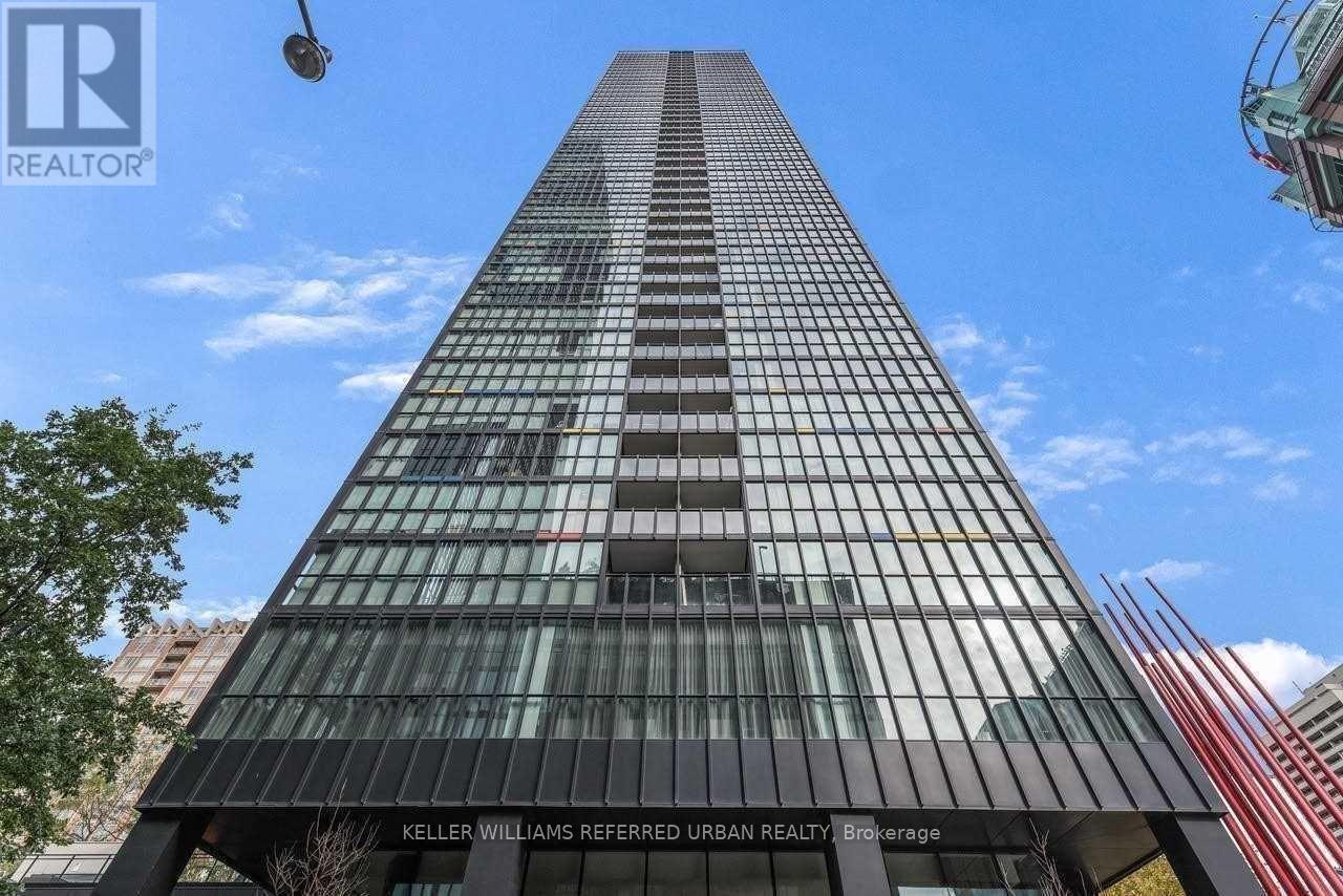 A tall building with a glass facade is the focus of this image.