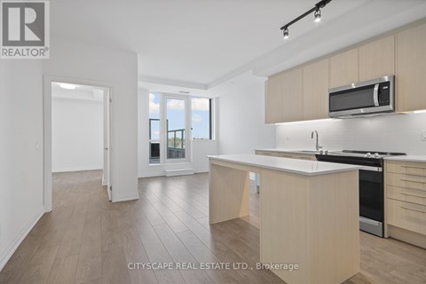 A modern kitchen with wooden cabinets and a white countertop.