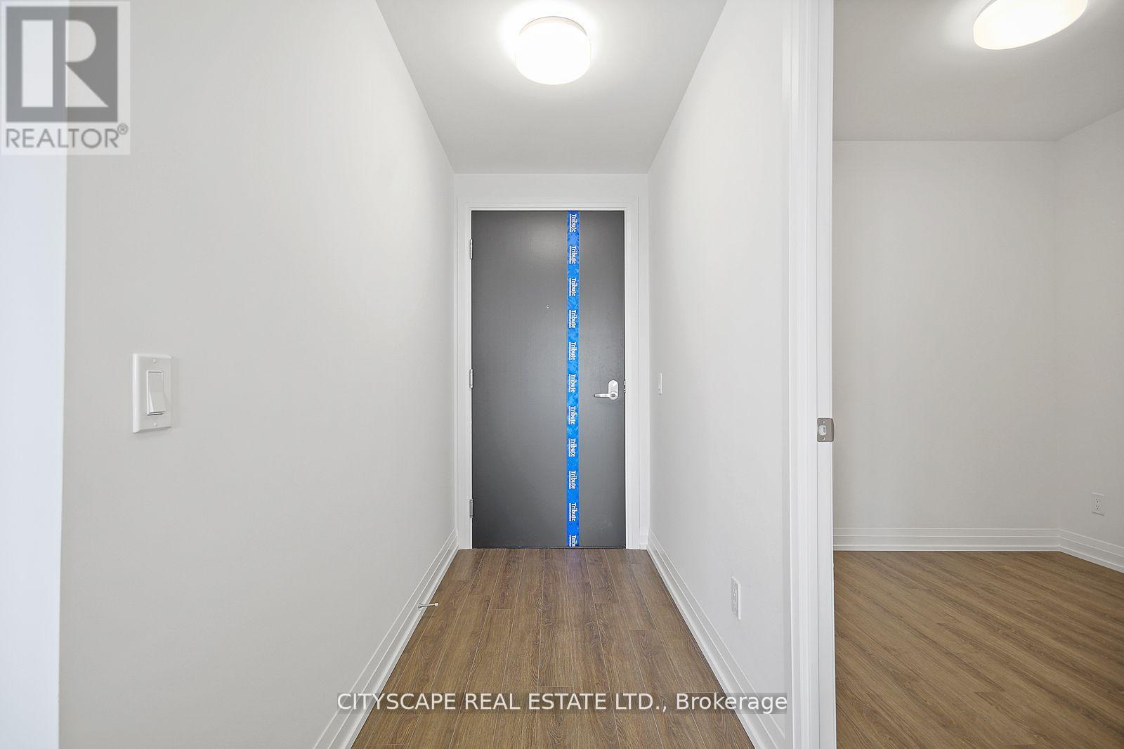 A room with a door and a wall socket.