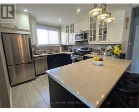 A kitchen with a large island and stainless steel appliances.