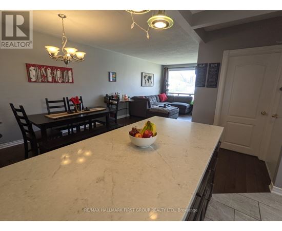 A kitchen with a marble countertop and a bowl of fruit on it.
