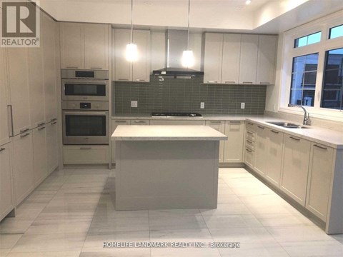 A kitchen with white cabinets and a central island.