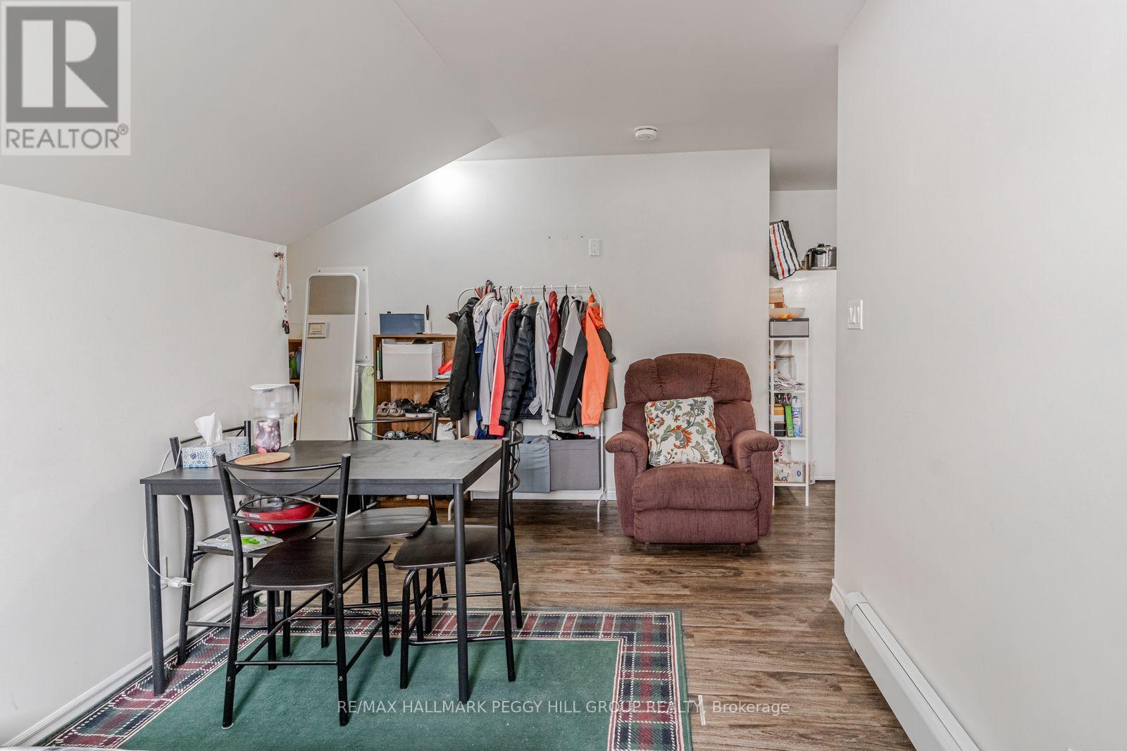 A room with a table and chairs and a couch.
